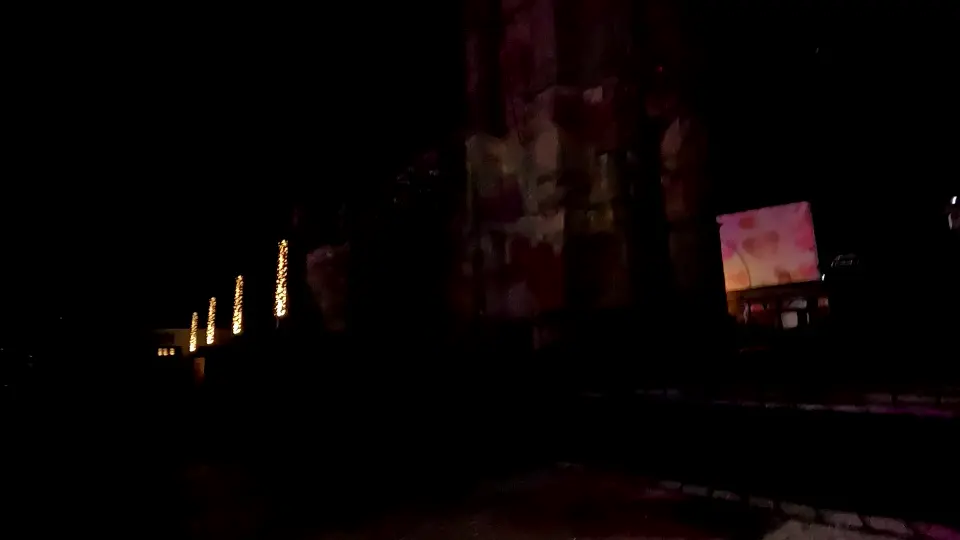 Dark nighttime scene in Landerneau with minimal lighting and atmospheric shadows during lights festival