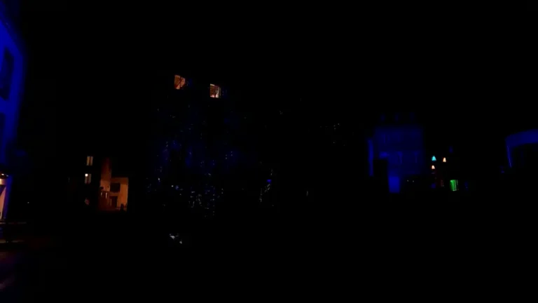 Continued theatrical light projection performance on Landerneau building facade with dynamic patterns and colors