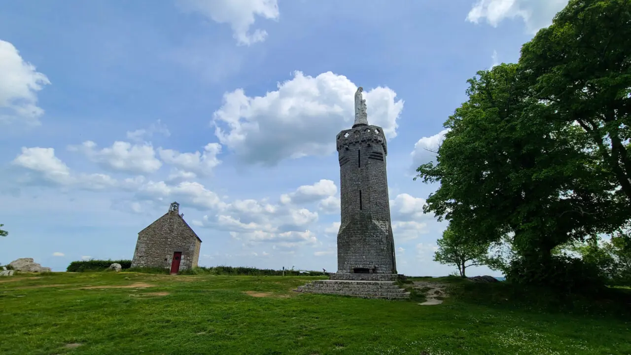 Chapelle Notre Dame de l'Espérance stone chapel and memorial tower on Mont-Dol hilltop with statue and panoramic countryside views in Brittany