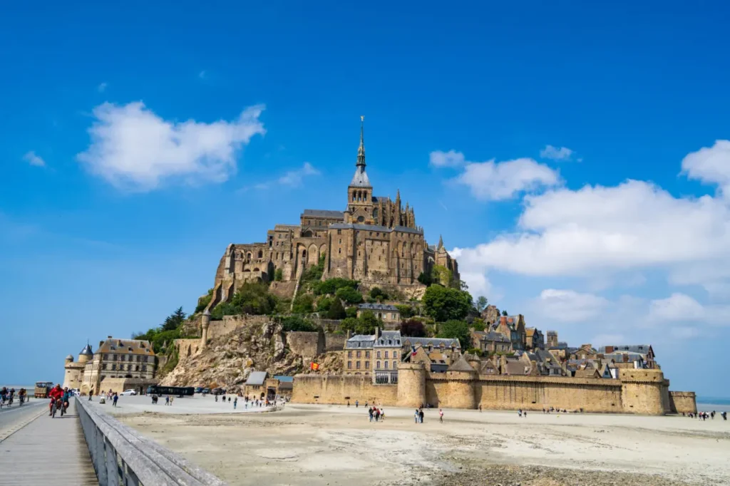 Mont Saint-Michel abbey close-up view from Passerelle bridge showing Gothic architecture and medieval walls